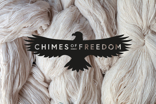 Photo of raw cotton with Chimes of Freedom brand logo