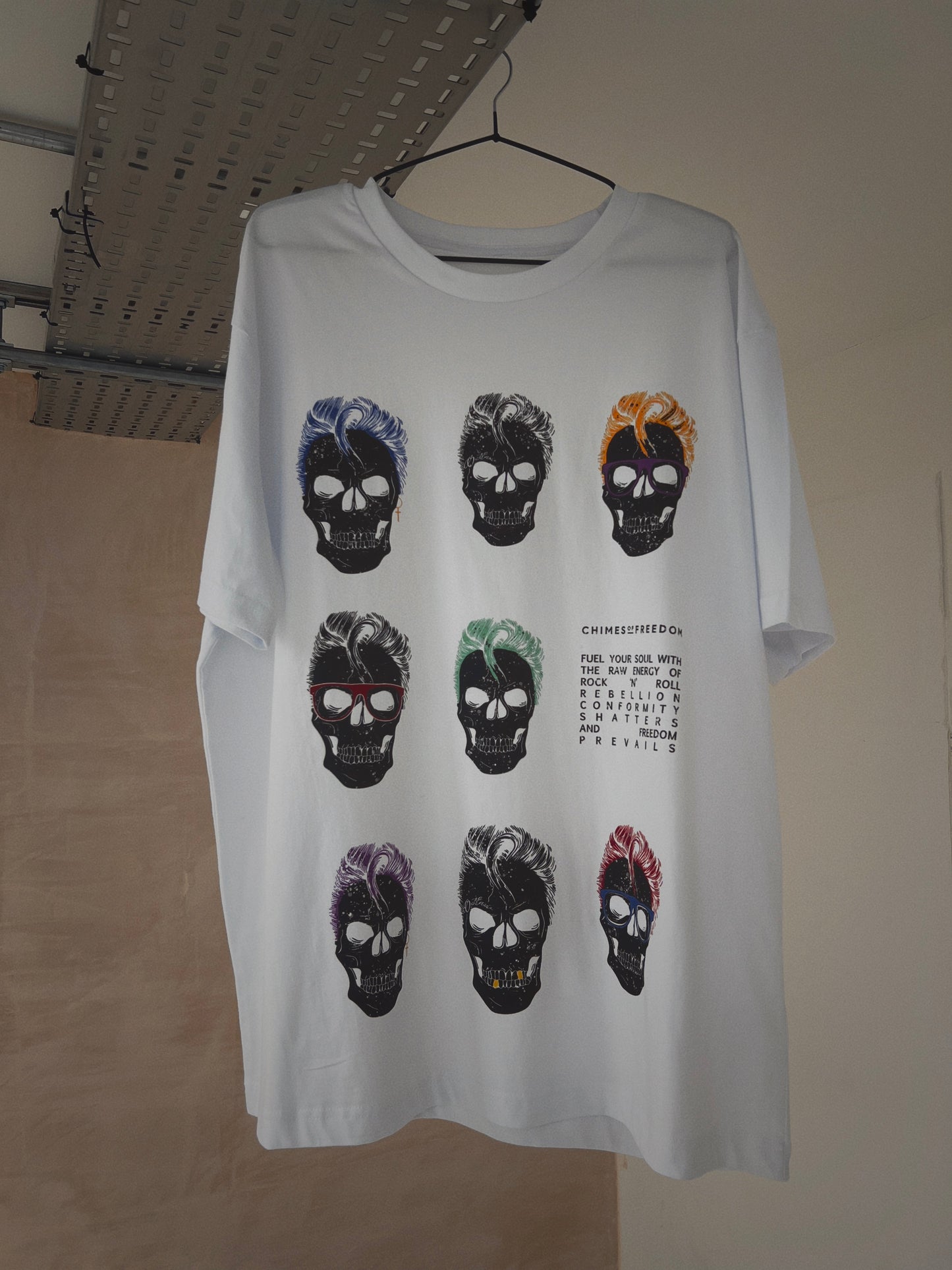 A white t-shirt with skull design hanging