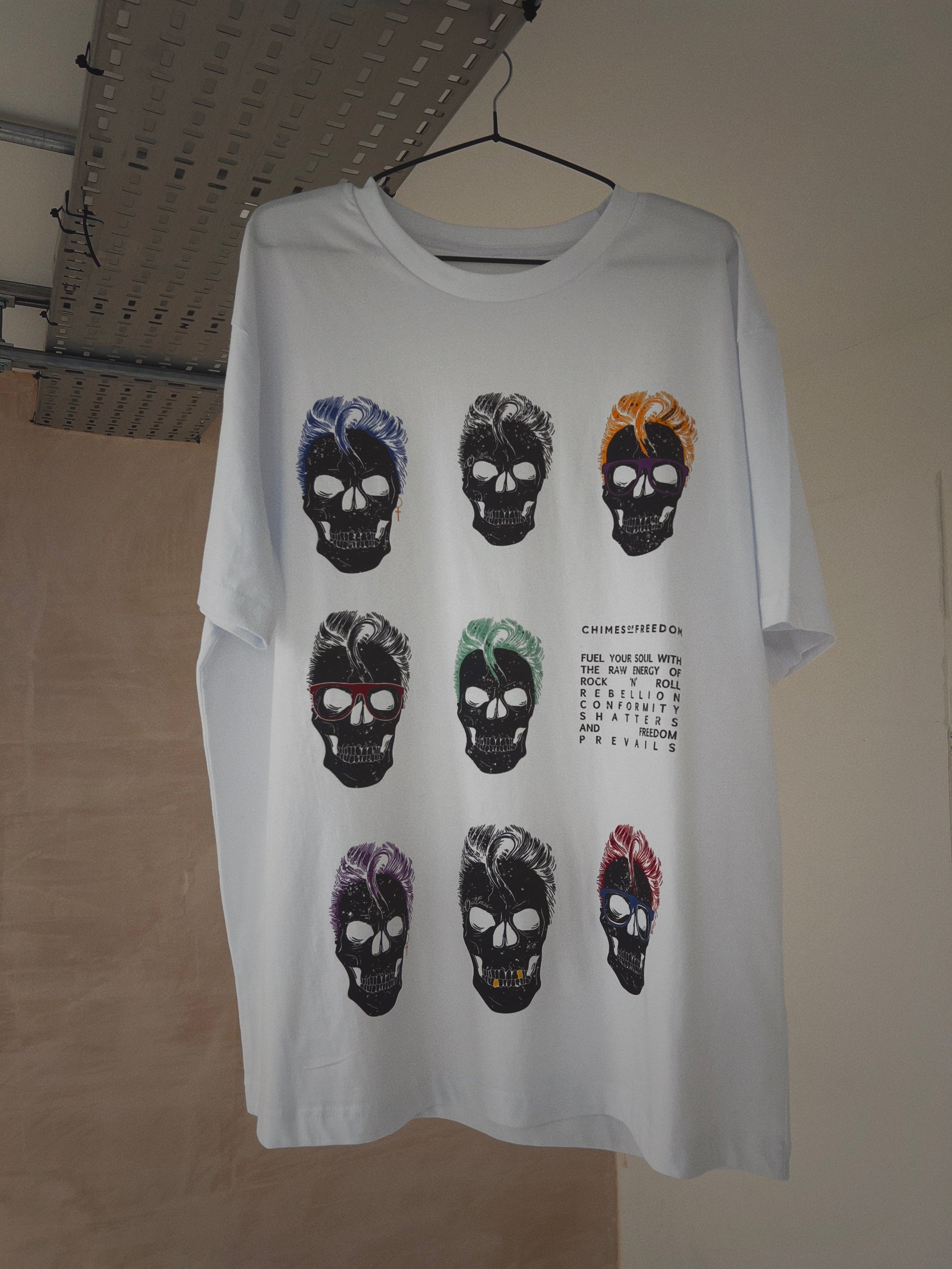 A white t-shirt with skull design hanging