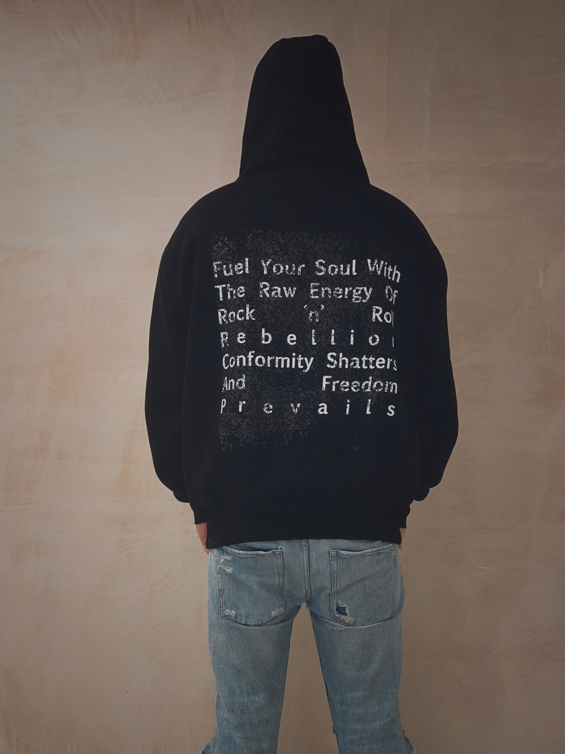 Male wearing a black oversized hoodie with slogan on