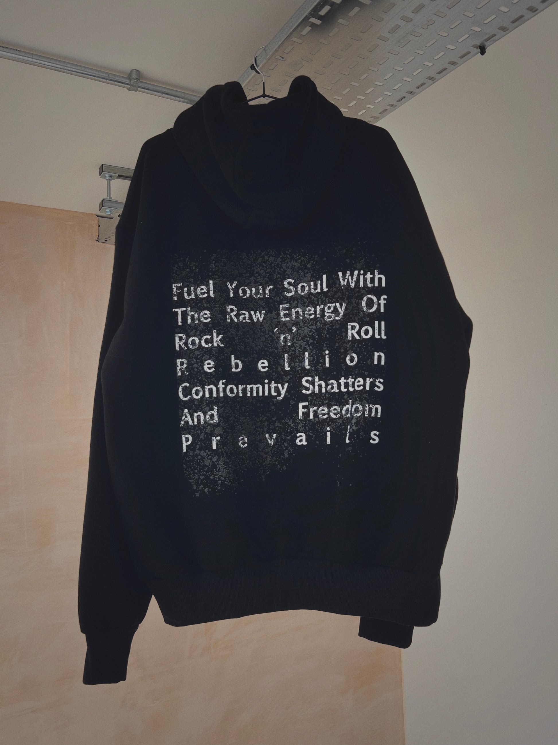 A black oversized hoodie with slogan on